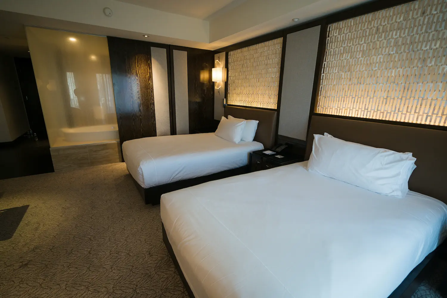 Hotel room with a dog bed, food bowls, and pet welcome kit